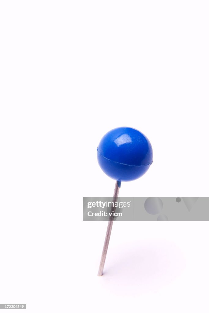 A blue pushpin isolated on white background