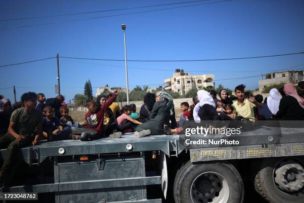 Palestinians with their belongings flee to safer areas in Gaza City after Israeli air strikes, on October 13, 2023. Israel has called for the...