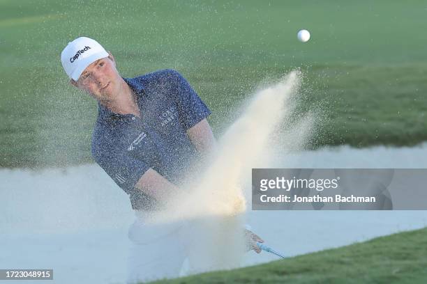 Ben Griffin of the United States plays a shot from a bunker on the 18th hole during the third round of the Sanderson Farms Championship at The...