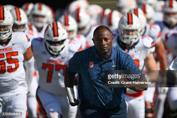 Head coach Dino Babers of the Syracuse Orange leads his team onto the fieldf for their game against the North Carolina Tar Heels at Kenan Memorial...