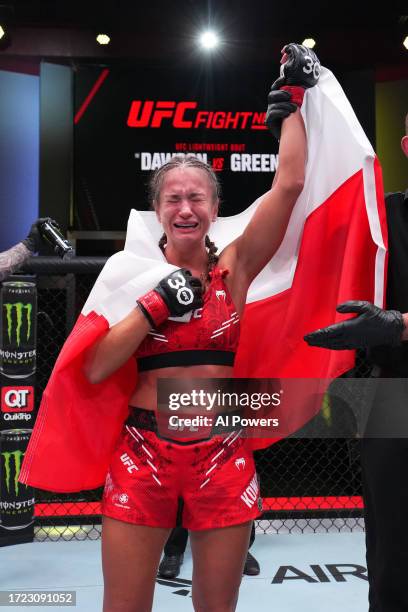 Karolina Kowalkiewicz of Poland reacts after defeating Diana Belbita of Romania in a strawweight fight during the UFC Fight Night weigh-in at UFC...