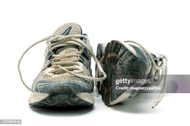 pair of old used running shoes isolated on white background - sports shoe stock pictures, royalty-free photos & images