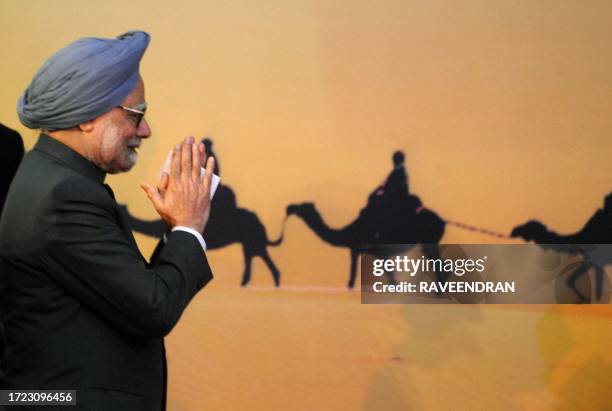 Indian Prime Minister Manmohan Singh greets delegates during the opening ceremony of the tenth Pravasi Bharatiya Divas 2012 in Jaipur on January 8,...