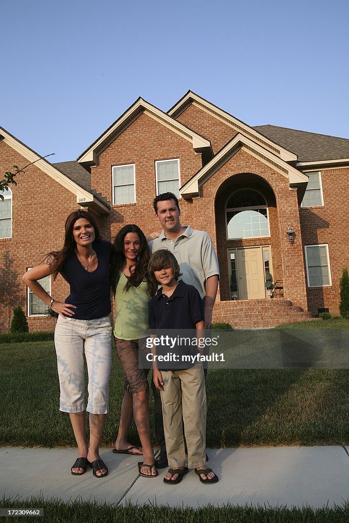 Family in front of brick house