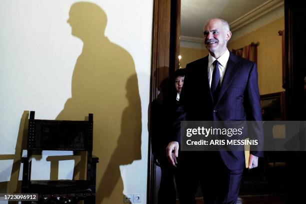 Greek Prime Minister George Papandreou arrives at a meeting of Greek political party leaders in the presidential palace in Athens on November 10,...