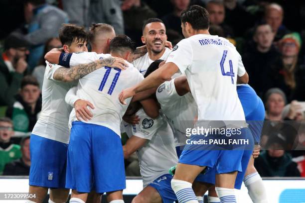Greece's striker Giorgos Masouras celebrates with teammates after scoring their second goal during the UEFA Euro 2024 group B qualification football...