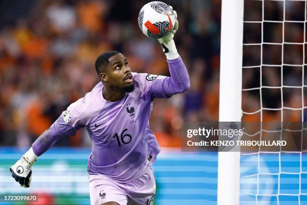 France's goalkeeper Mike Maignan controls the ball during the Euro 2024 qualifying football match between the Netherlands and France at the Johan...