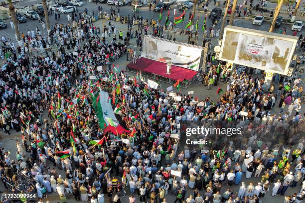 This aerial view shows demonstrators gathering for a rally in solidarity with the Palestinian people at the Martyrs' Square in Tripoli on October 13,...