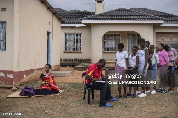 Swati woman sits on a straw mat as Swati maidens register ahead of their trip to the Mbangweni Royal Residence for of the 2023 Umhlanga Reed Dance...