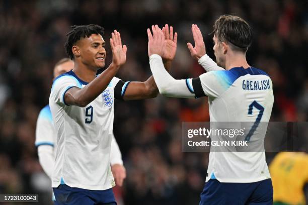 England's striker Ollie Watkins celebrates with England's midfielder Jack Grealish after scoring the opening goal of the international friendly...