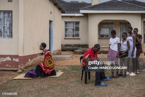 Swati woman kneels on a straw mat as Swati maidens register ahead of their trip to the Mbangweni Royal Residence for of the 2023 Umhlanga Reed Dance...