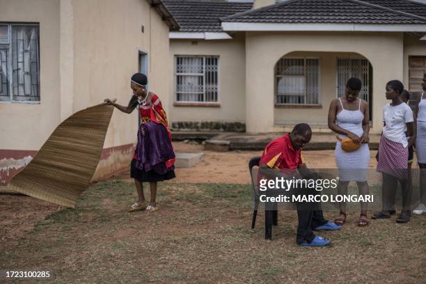 Swati woman prepares a straw mat as Swati maidens register ahead of their trip to the Mbangweni Royal Residence for of the 2023 Umhlanga Reed Dance...