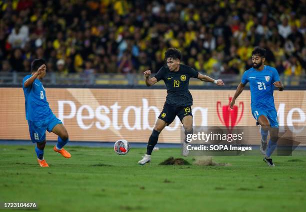 Muhammad Akhyar Bin Abdul Rashid of Malaysia and Suresh Singh Wangjam and Nikhil Chandrashekhar Poojary of India in action during the Merdeka Cup...