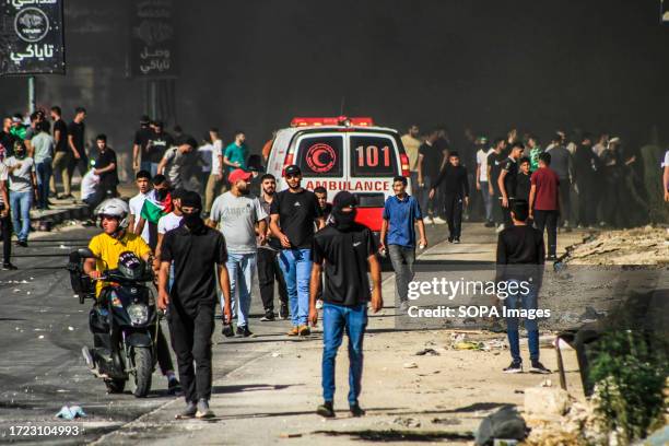 Palestinian protesters throw stones at Israeli forces during a demonstration in support of Gaza, which has been under Israeli air strikes since...