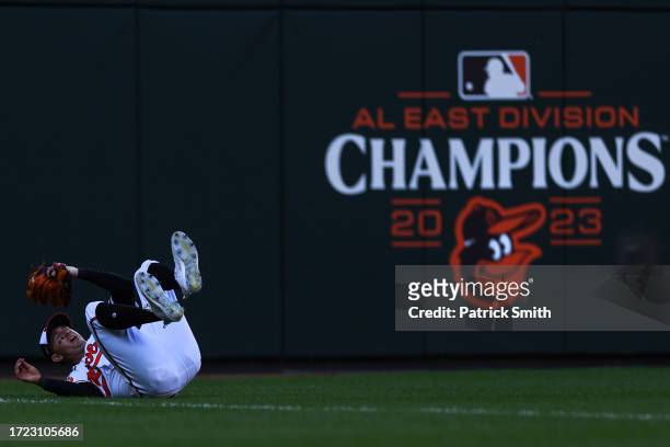 Austin Hays of the Baltimore Orioles makes a diving catch during the seventh inning of Game One of the American League Division Series against the...