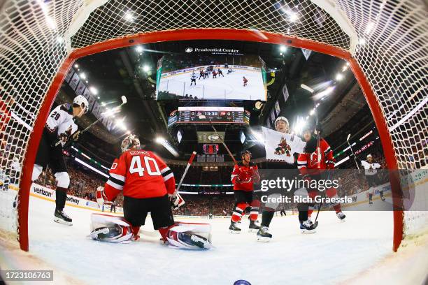 Clayton Keller of the Arizona Coyotes celebrates a goal by Matt Dumba of the Arizona Coyotes in the first period of the game against the New Jersey...