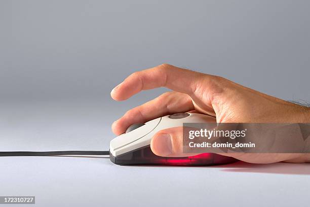 man's hand holding in hand optical mouse with scroll, studio - right click stock pictures, royalty-free photos & images