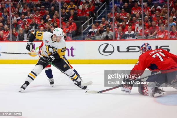 Lars Eller of the Pittsburgh Penguins is stopped by Charlie Lindgren of the Washington Capitals on a scoring opportunity during a game at Capital One...