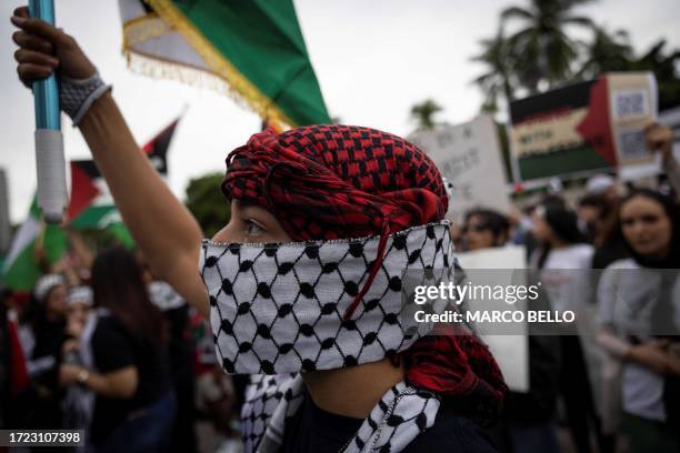 People attend a rally in support of Palestinians in the Gaza Strip at Bayfront Park in Miami, Florida, on October 13, 2023. Thousands of Palestinians...