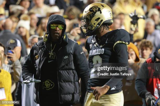 Head coach Deion Sanders and Shedeur Sanders of the Colorado Buffaloes talk before taking on the Stanford Cardinal at Folsom Field on October 13,...