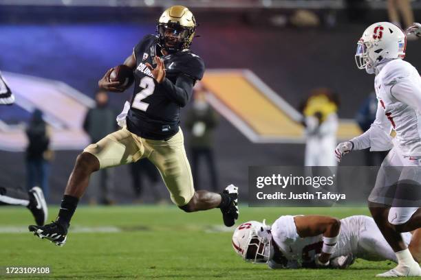 Shedeur Sanders of the Colorado Buffaloes runs with the ball against the Stanford Cardinal during the first quarter at Folsom Field on October 13,...