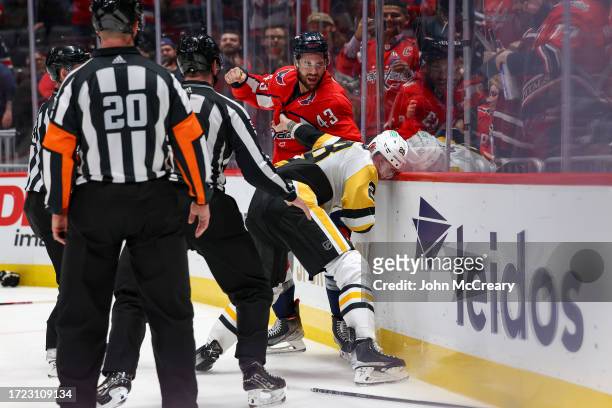 Tom Wilson of the Washington Capitals fights Marcus Pettersson of the Pittsburgh Penguins during a game at Capital One Arena on October 13, 2023 in...