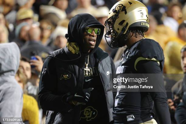 Head coach Deion Sanders and Shedeur Sanders of the Colorado Buffaloes talk before taking on the Stanford Cardinal at Folsom Field on October 13,...