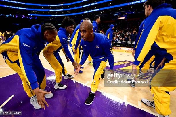 Chris Paul of the Golden State Warriors high fives Golden State Warriors players before the game against the Los Angeles Lakers on October 13, 2023...