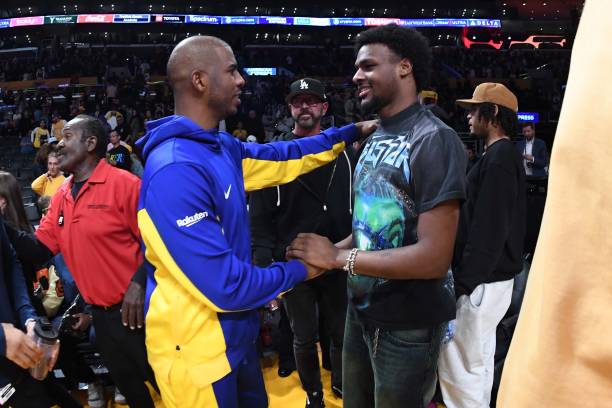 Chris Paul of the Golden State Warriors and Bronny James talk after the game against the Los Angeles Lakers on October 13, 2023 at Crypto.Com Arena...