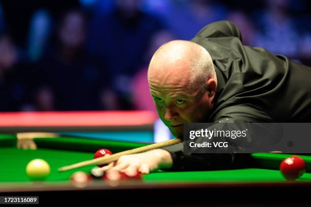 John Higgins of Scotland plays a shot in the Semifinal match against Judd Trump of England on day 6 of 2023 BetVictor English Open at the Brentwood...