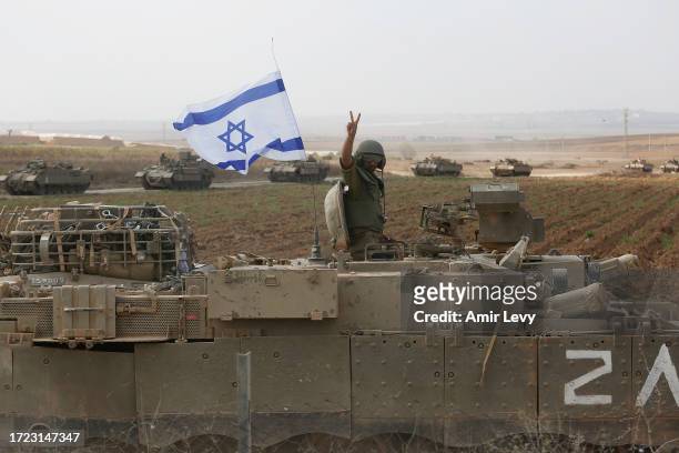 Soldier poses for photos atop a tank near the border with Gaza on October 14, 2023 near Sderot, Israel. Israel has sealed off Gaza and launched...