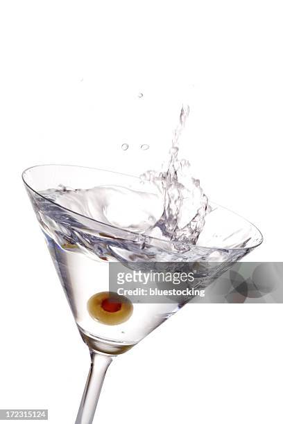 a cocktail with olive splashing - splashing cocktail stock pictures, royalty-free photos & images