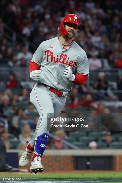 Bryce Harper of the Philadelphia Phillies round bases and reacts after hitting a solo home run during the sixth inning against the Atlanta Braves...