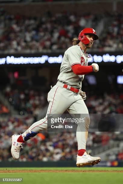 Bryce Harper of the Philadelphia Phillies round bases and reacts after hitting a solo home run during the sixth inning against the Atlanta Braves...