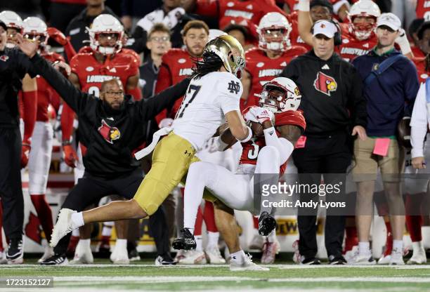 Quincy Riley of Louisville Cardinals intercepts a pass against the Notre Dame Fighting Irish at L&N Stadium on October 07, 2023 in Louisville,...