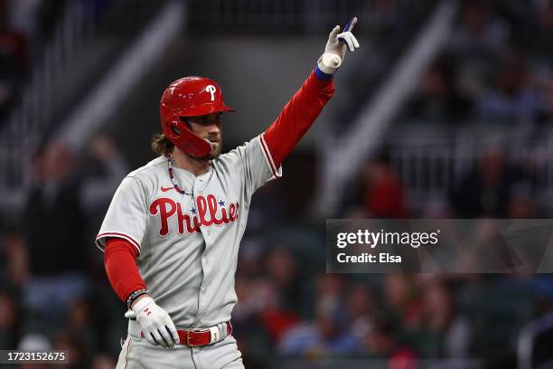 Bryce Harper of the Philadelphia Phillies reacts after hitting a solo home run during the sixth inning against the Atlanta Braves during Game One of...