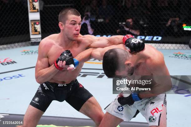 Alexander Hernandez punches Bill Algeo in a featherweight fight during the UFC Fight Night weigh-in at UFC APEX on October 07, 2023 in Las Vegas,...