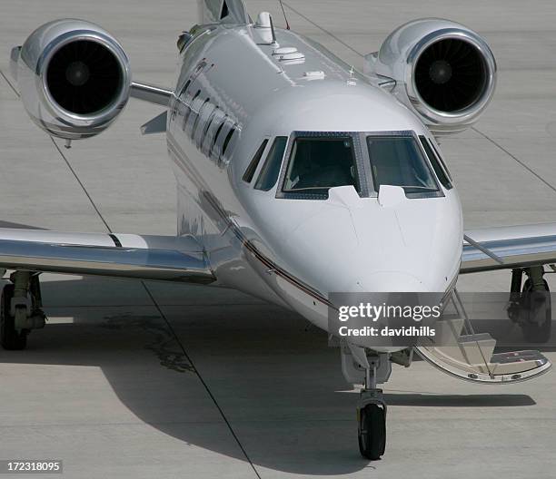 private business jet for first class travel on tarmac - jet privé stockfoto's en -beelden