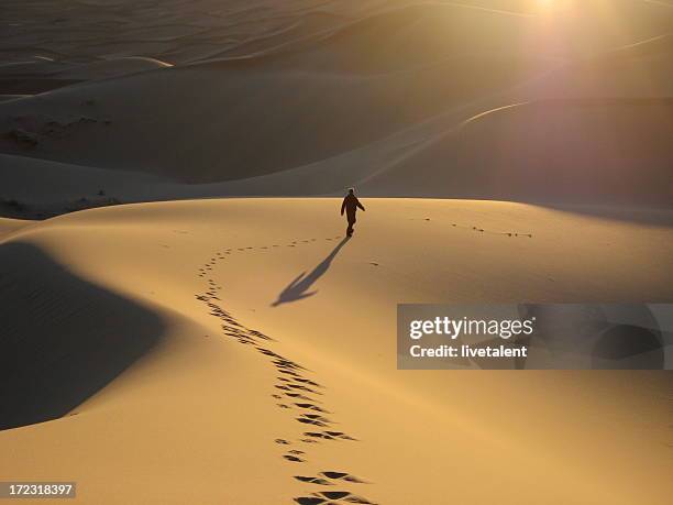 man walking dunes at sunrise - footprint stock pictures, royalty-free photos & images