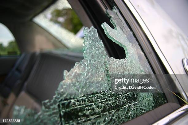broken car glass with warning label - breaking window stockfoto's en -beelden