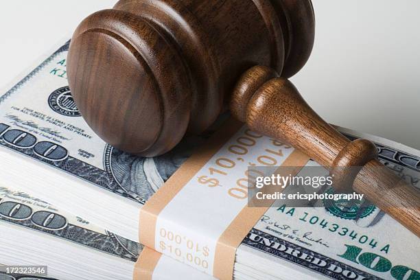 judge gavel on 100 dollar bills - exploitation stock pictures, royalty-free photos & images