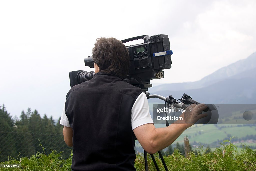 Operating A Camera Man Operating Video Camera In Mountains High-Res Stock Photo - Getty Images