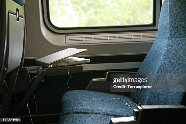 a seat on a train being used as a workstation - seat stock pictures, royalty-free photos & images