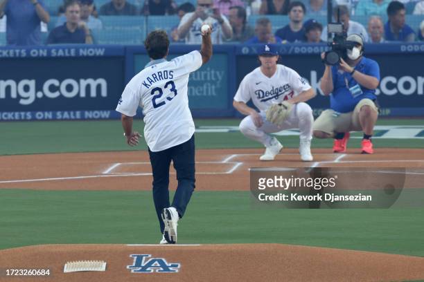Former MLB player Eric Karros throws a ceremonial first pitch before Game One of the Division Series between the Arizona Diamondbacks and the Los...
