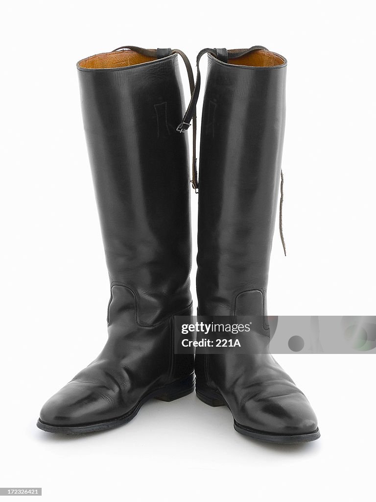 Black leather riding boots on white