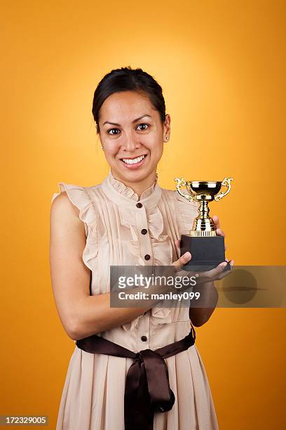female holding trophy - holding trophy stock pictures, royalty-free photos & images
