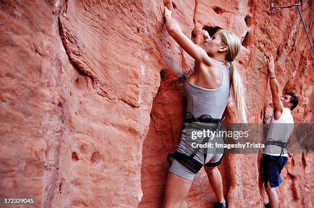 man and woman rock climbers at st. george in utah - st george utah stock pictures, royalty-free photos & images