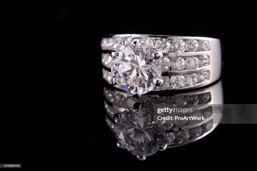 Diamond ring reflected on black background