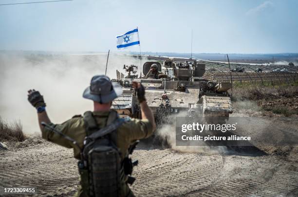 October 2023, Israel, Sderot: Israeli military combat vehicles and tanks are seen near the Israeli-Gaza border as fighting between Israeli troops and...