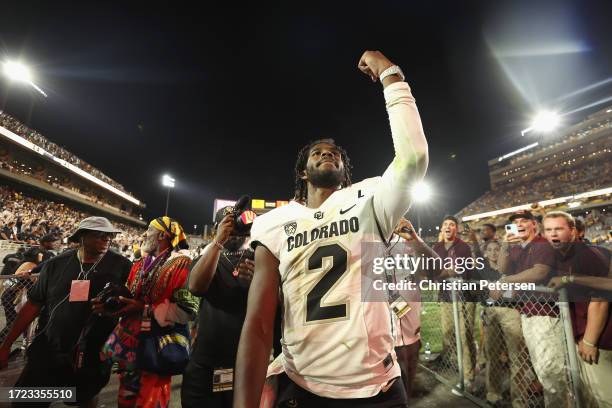 Quarterback Shedeur Sanders of the Colorado Buffaloes celebrates as he walks off the field following the NCAAF game against the Arizona State Sun...